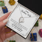 A woman is holding a ShineOn Fulfillment gift box with a Remember Whose Wife You Are Forever Love Necklace - Gift for Wife from Husband inside.