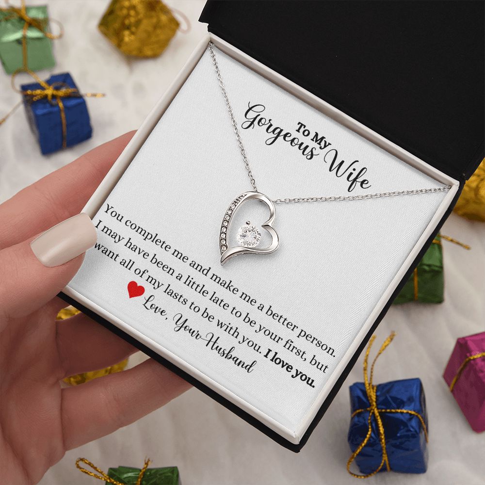 A woman is holding a gift box with a You Complete Me Forever Love Necklace - To Wife from Husband by ShineOn Fulfillment in it.