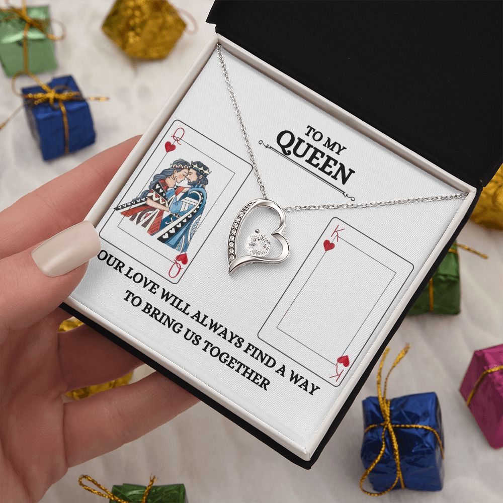 A woman is holding a To My Queen Forever Love necklace by ShineOn Fulfillment with a heart on it.