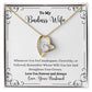 A Remember Whose Wife You Are Forever Love Necklace - Gift for Wife from Husband, branded by ShineOn Fulfillment, with the words "to my badass wife.