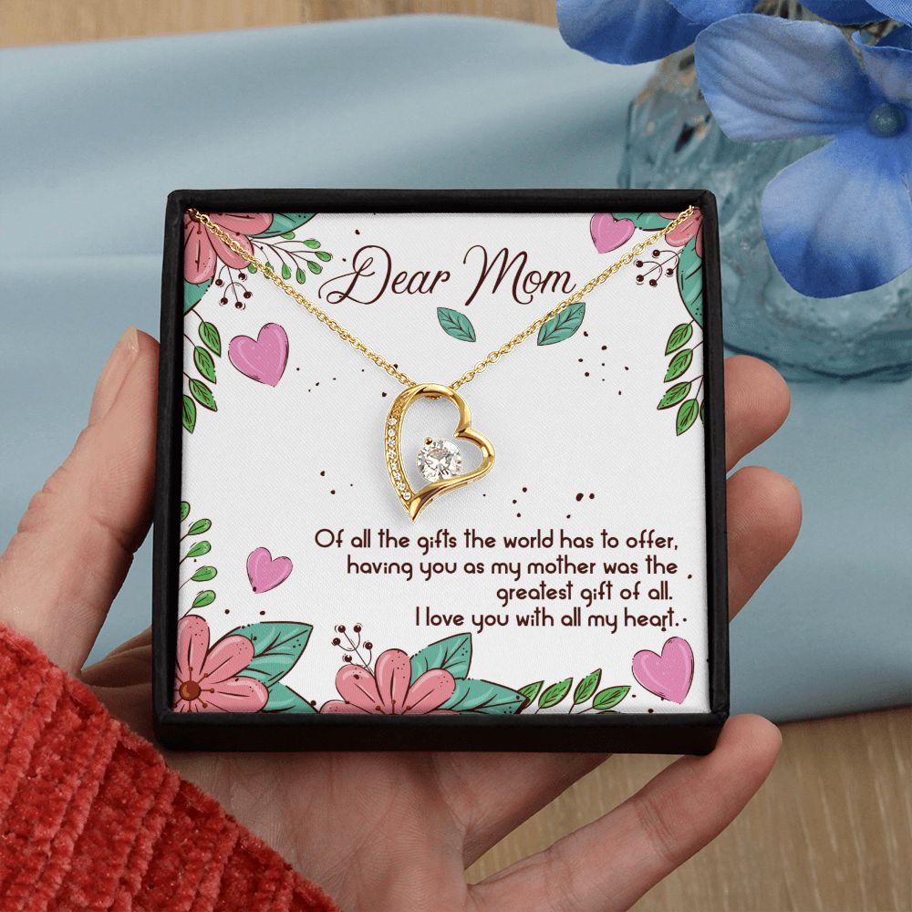 A woman holding a ShineOn Fulfillment To Mom - The Greatest Gift of All - Forever Love Necklace.