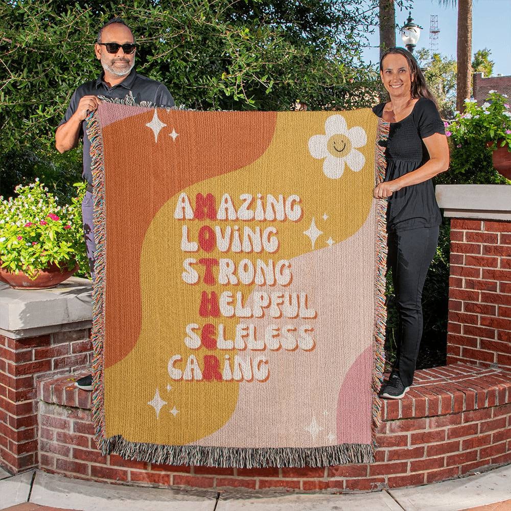 A woman and man holding a Golden Value SG Amazing Loving Mother Definition Heirloom Woven Blanket.