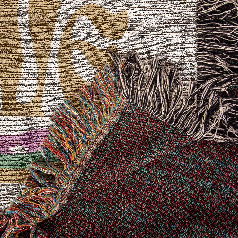 A close-up of a colorful fringed rug, reminiscent of a Super Mom Super Wife Super Love Heirloom Woven Blanket by Golden Value SG.