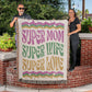 Two individuals wrapping themselves in a Golden Value SG Super Mom Super Wife Super Love Heirloom Woven Blanket with the words "Super Mom" and "Super Wife" printed on it.