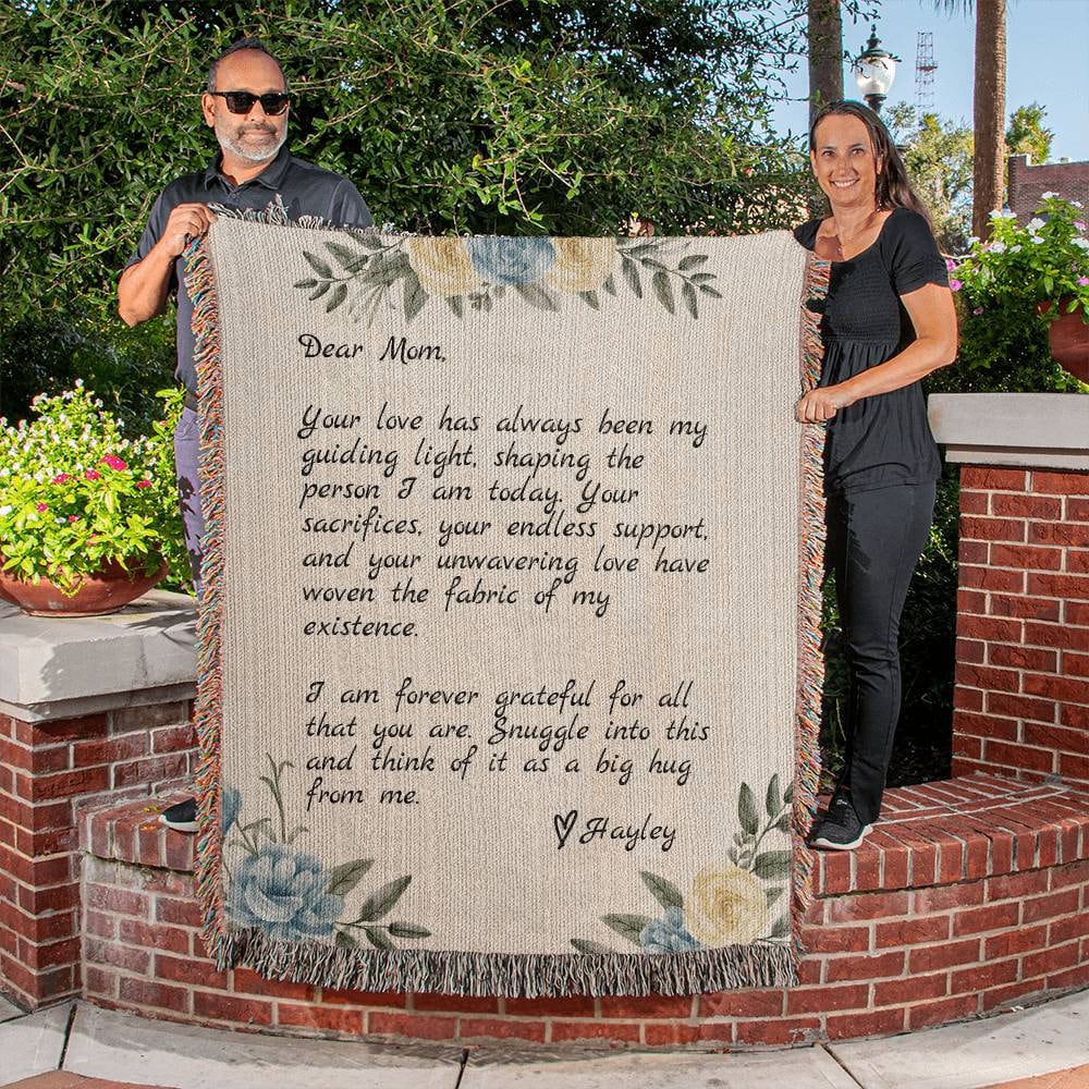A man and woman holding up a Golden Value SG Personalized Note to Mom Heirloom Woven Blanket For Mom with a poem on it.