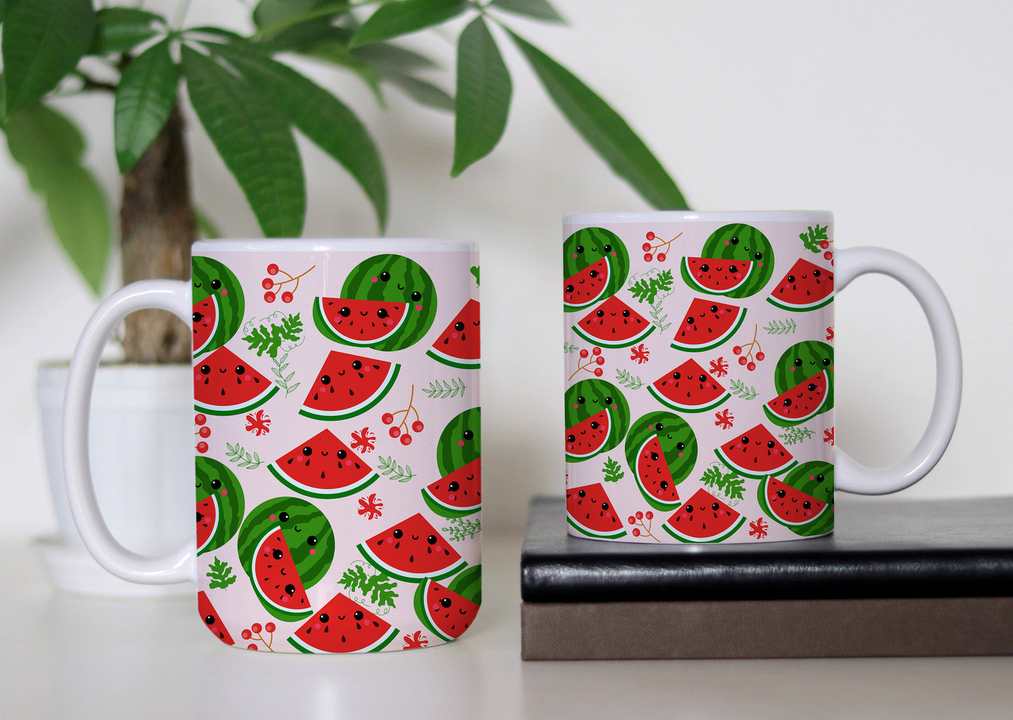 Description: Two Gearbubble Cute Watermelon Print Mugs on Pink Background  with watermelon print on a desk, one on a book and one beside a potted plant, ready to be gifted.