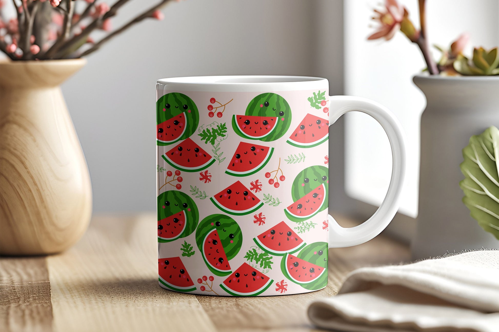 A Gearbubble gift mug with a cute watermelon print on a pink background and snowflake pattern on a table.