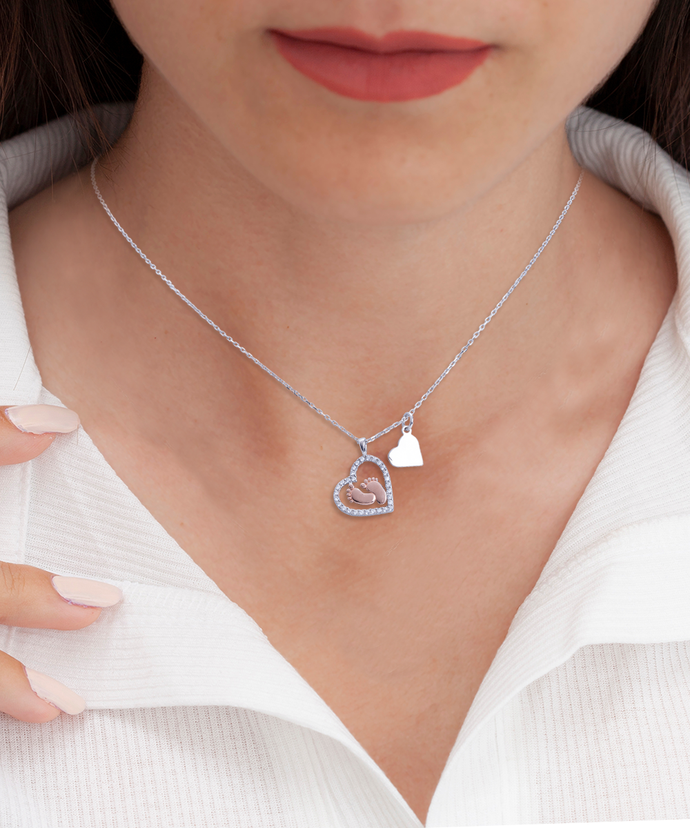 A woman wearing a Gearbubble necklace with a heart-shaped pendant, perfect as a Mother's Day Gift.